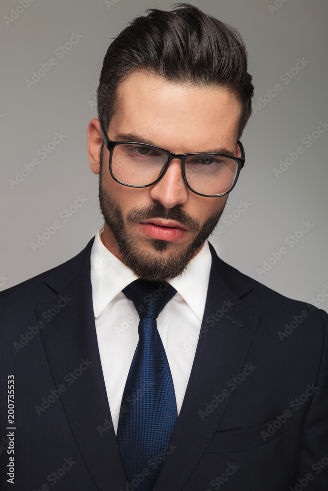 portrait of serious businessman with glasses thinking portrait of serious businessman with glasses thinking