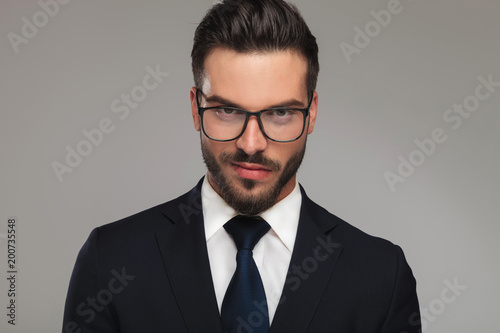 handsome businessman with sunglasses showing contempt photo