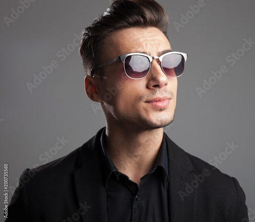 portrait of handsome fashion man with sunglasses looking to side