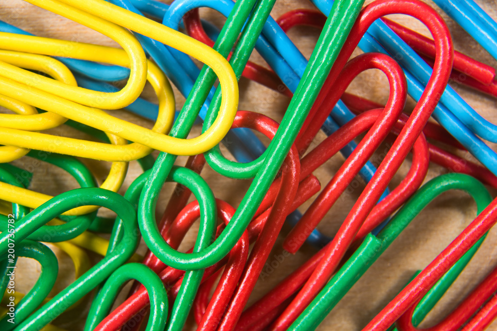 Many colorful paper clips on a macro table Many colorful paper clips on a macro table