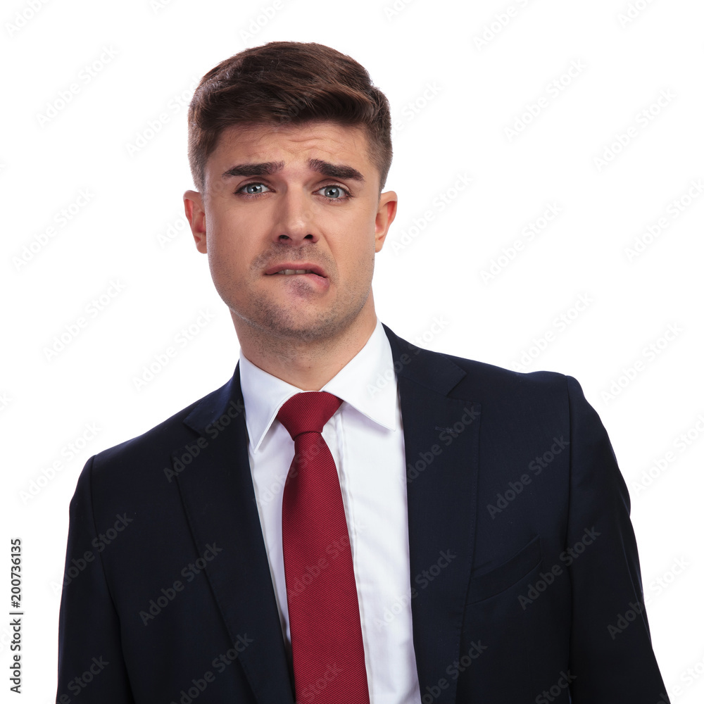businessman biting his lip and making a funny scared face businessman biting his lip and making a funny scared face
