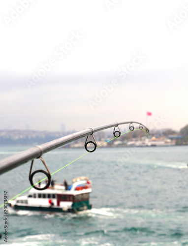 Fishing on galata bridge and view of istanbul on background, selective focus