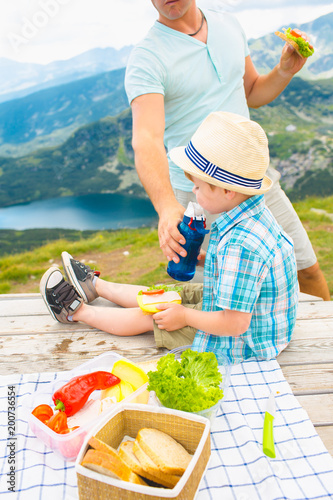 Family on a picnic in the mountains photo