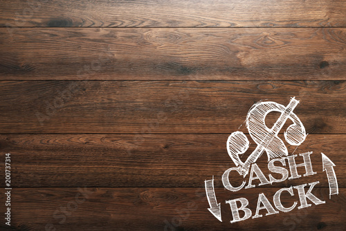 Inscription Cash Back, an image of the emblem on a wooden background. Icon, A symbol of cash back. The concept of business, finance.
