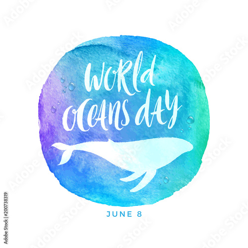 World oceans day emblem - brush calligraphy and whale silhouette on a watercolor circle background. Vector illustration.