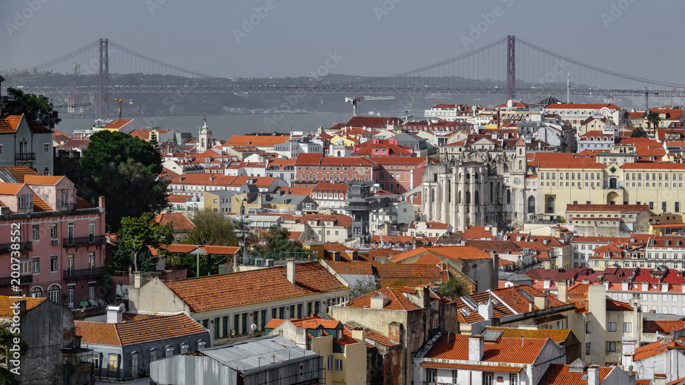 Red tiled rooftops with the bridge creating a line on the horizon of Lisbon