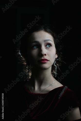 beautiful brunette girl with playful smile on dark background