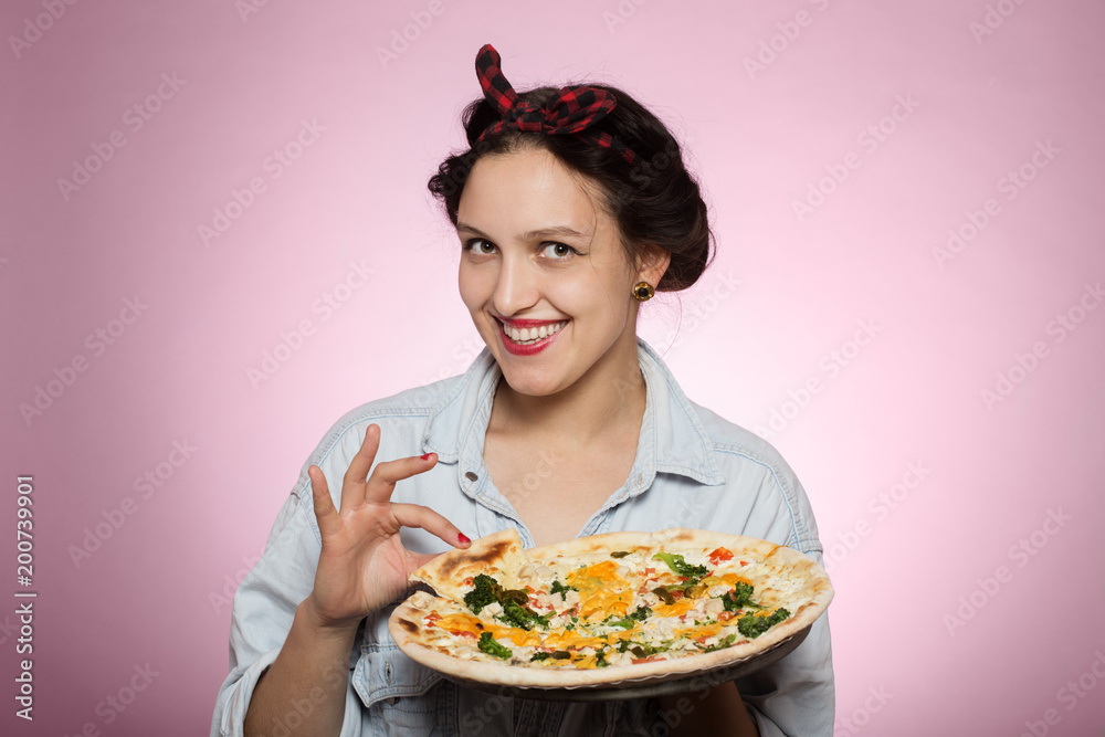 woman presents pizza