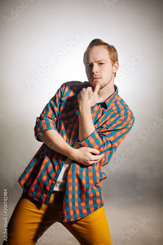 close up photo of stilysh ginger man with beard touching his chin. thinking process. brutal man photo