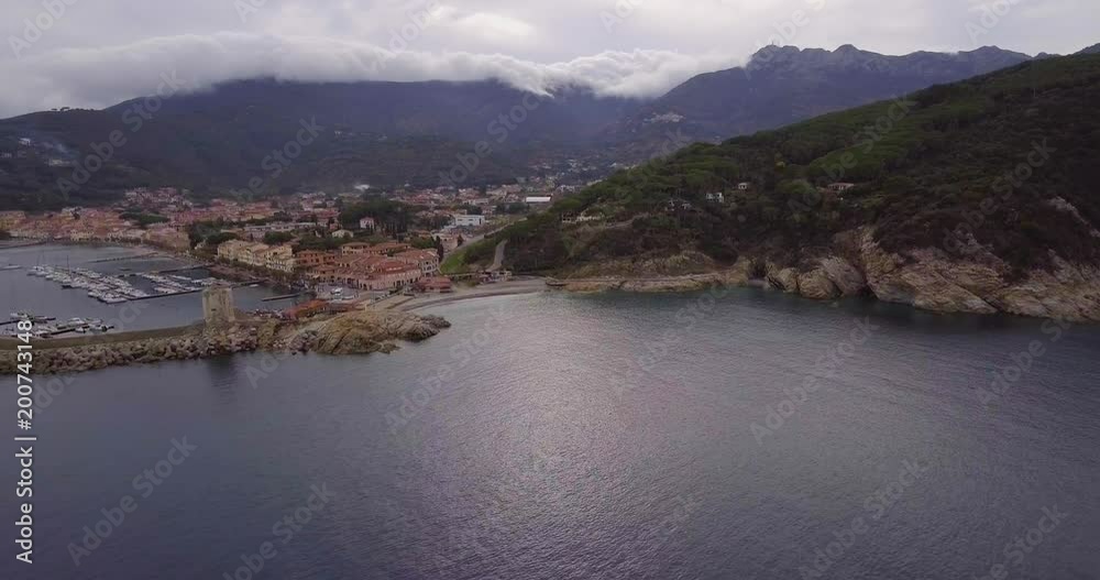 Aerial, beautiful bay and a little port of Marciana Marina on Elba island in Tuscany, Italy on a cloudy day Aerial, beautiful bay and a little port of Marciana Marina on Elba island in Tuscany, Italy on a cloudy day