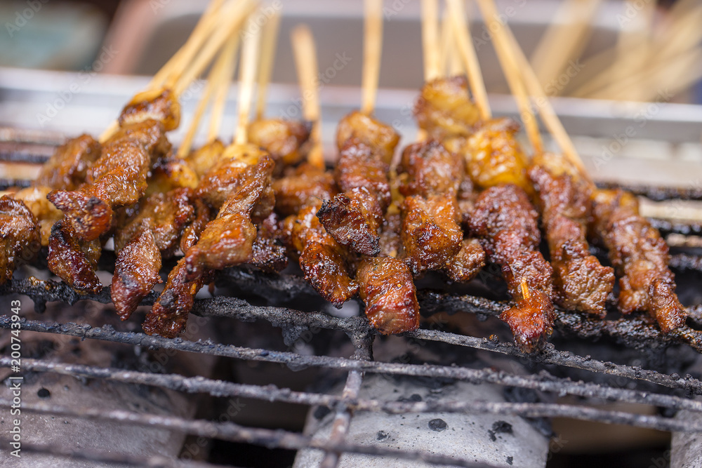 Indonesian grilled meats in wooden skewers, island Bali, Indonesia