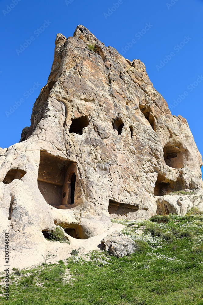 Cappadocia: Ancient  rock dwellings carved into natural volcanic rock formations in  the cappadocian landscape at Goreme