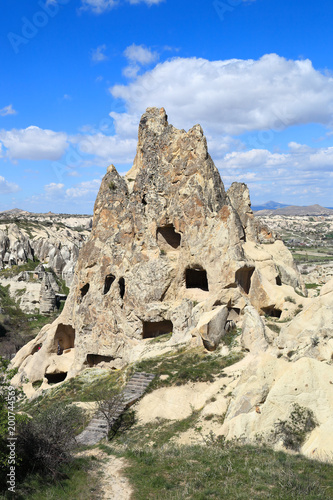 Cappadocia: Ancient rock dwellings carved into natural volcanic rock formations in the cappadocian landscape at Goreme