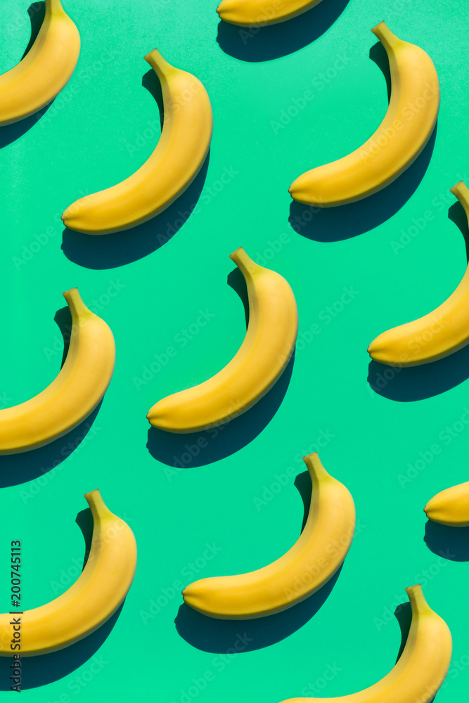 Ripe bananas on green surface