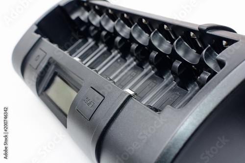 Obraz na płótnie Quick and soft eigth cell AA, AAA, C, D black ultimate professional battery charger on white background. w salonie