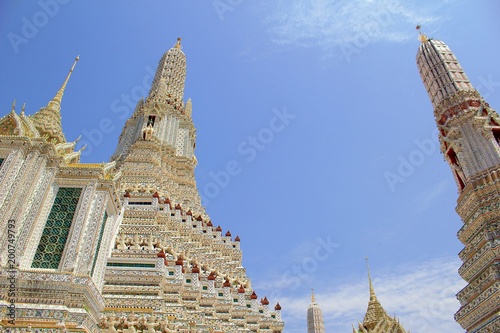 The scenery inside Wat Arun com pagoda, both small and big white background bright sky. © chaiyoot