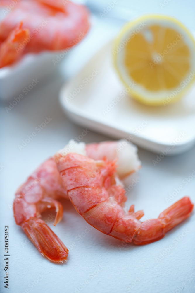 row tiger shrimp with lemon on white