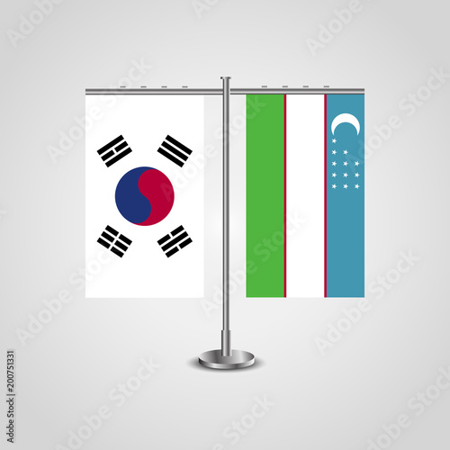 Table stand with flags of South Korea and Uzbekistan.Two flag. Flag pole. Symbolizing the cooperation between the two countries. Table flags