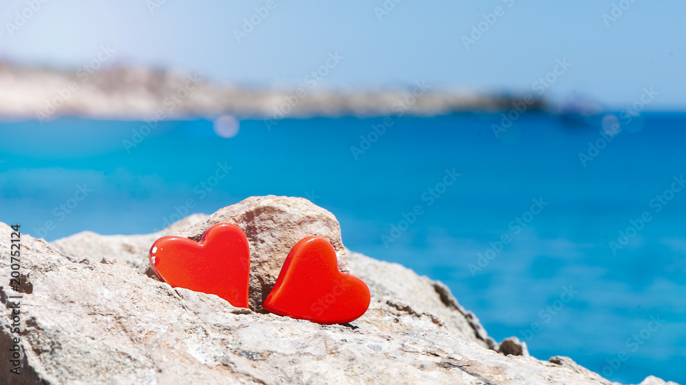 Concept of two hearts against the blue sea. I love the sea