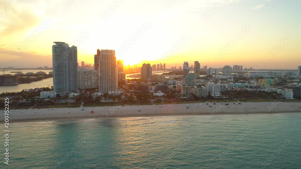 Aerial arrival Miami Beach Florida orange glowing sunset Aerial arrival Miami Beach Florida orange glowing sunset