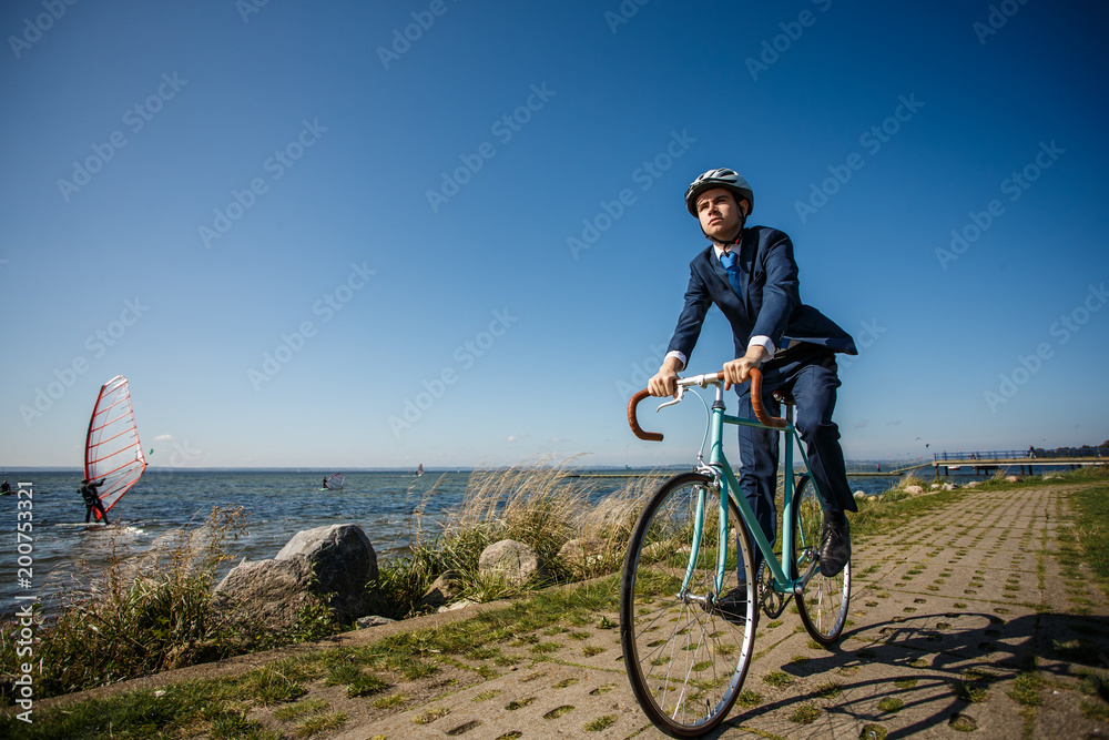 Fototapeta premium Businessman cycling at seaside