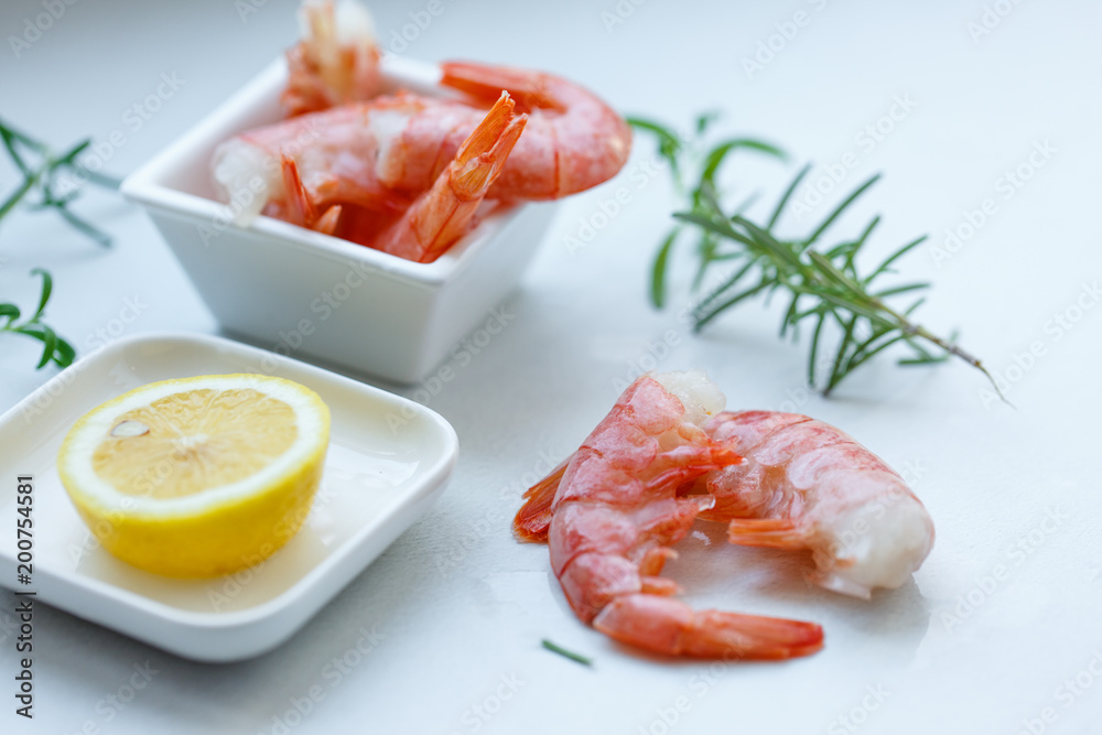 row tiger shrimp with lemon on white row tiger shrimp with lemon on white