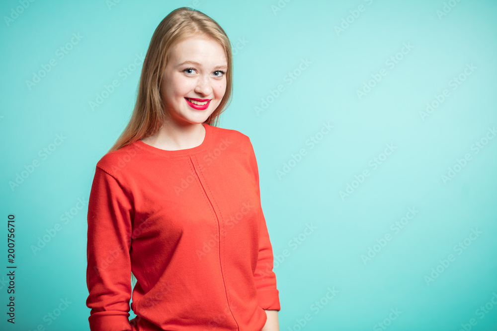 Portrait of amazed young girl looking at camera isolated on a blue bakground with copy space. Portrait of amazed young girl looking at camera isolated on a blue bakground with copy space.