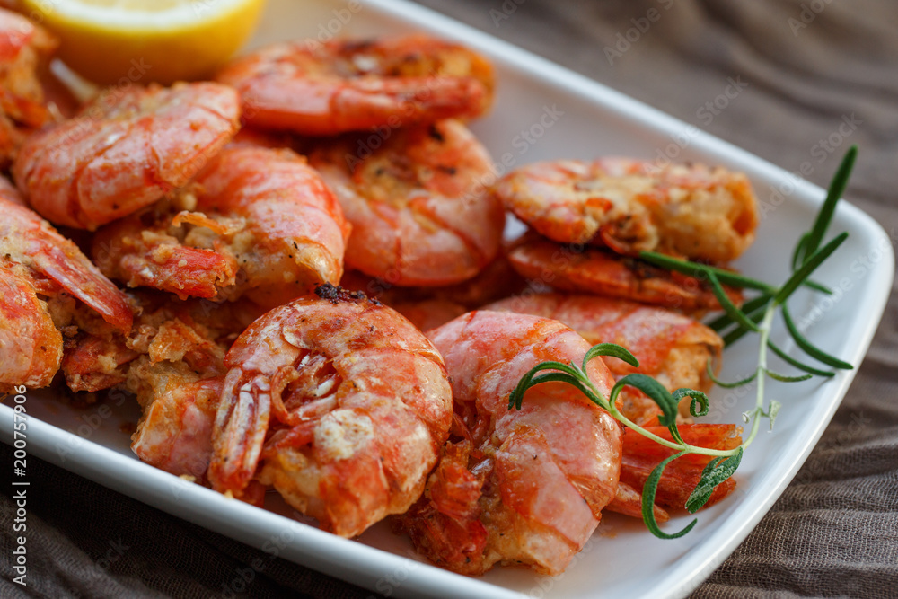 row tiger shrimp with lemon on brown row tiger shrimp with lemon on brown