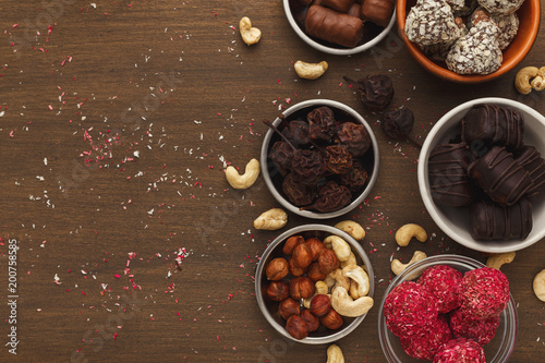 Wooden desktop with assortment of healthy sweets and nuts