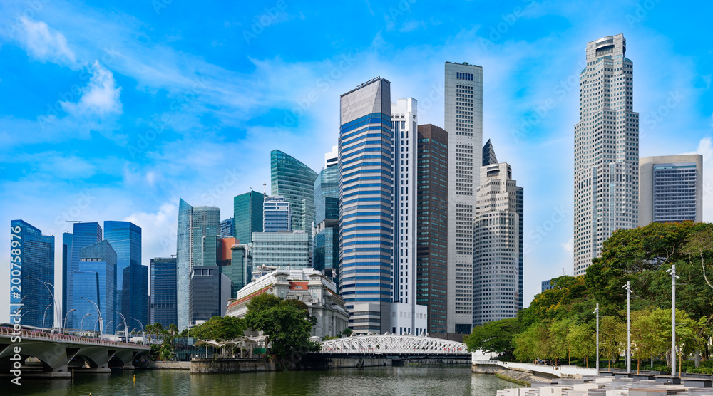 Panoramic view of Singapore business centre from Marina bay. Skyscrapers and tropical plants under deep blue sky