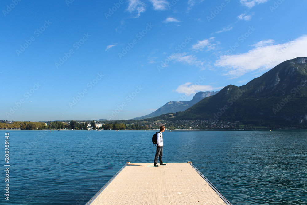 ANNECY, FRANCE - SEPTEMBER 22, 2012: Tourist walks on the pier in Annecy.