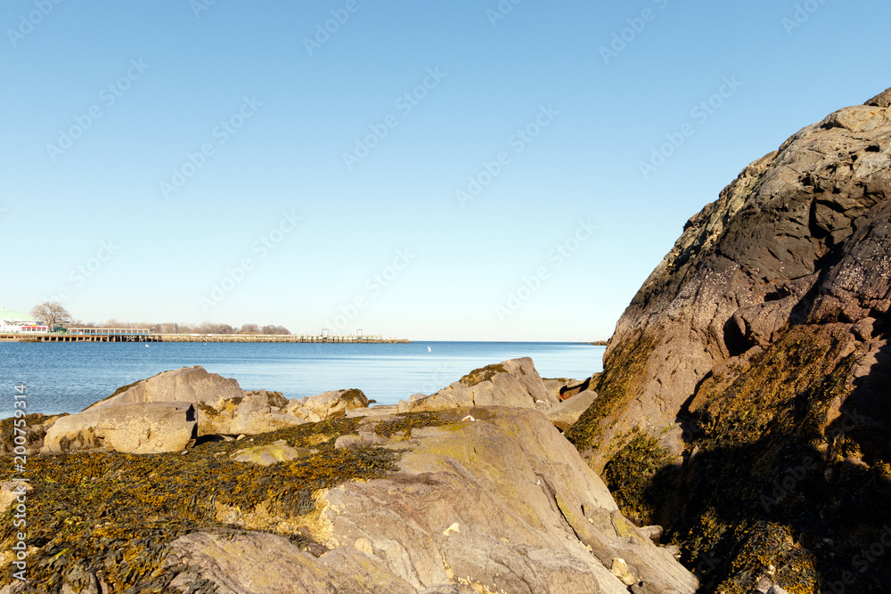 Beach scenic with boulders on the shore in Rye, New York, Westchester County