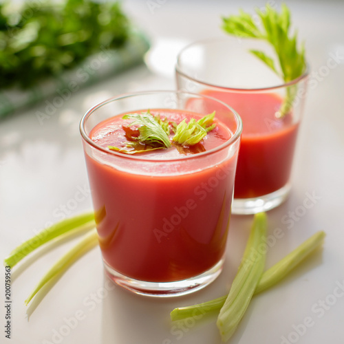 tomato juice in a glass with greens