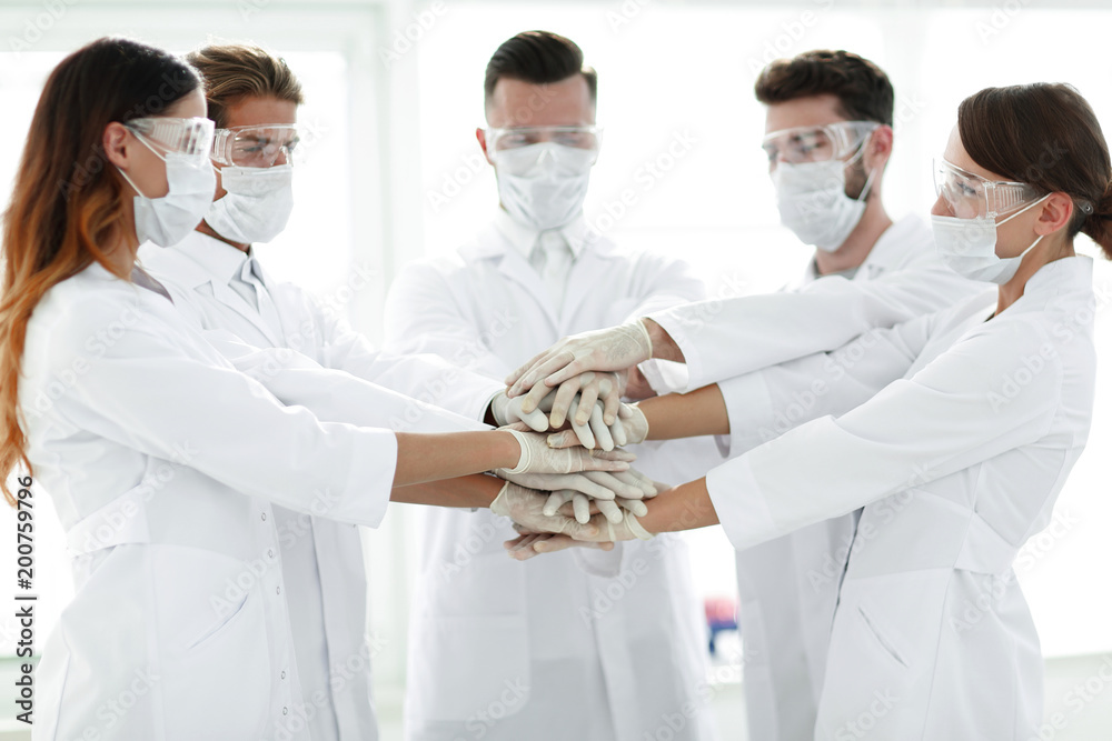 Close-up Photo Of Doctors Stacking Hand With Coworkers Close-up Photo Of Doctors Stacking Hand With Coworkers