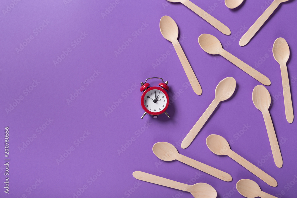Many wooden spoons on purple background, top view Many wooden spoons on purple background, top view