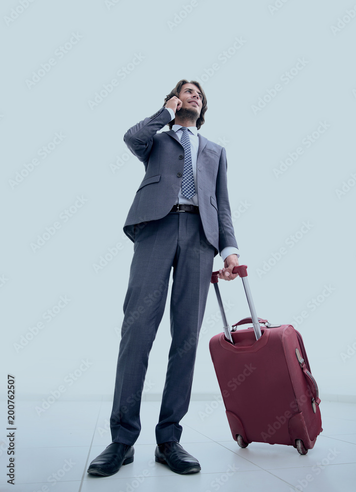 bottom view.businessman with Luggage talking on a cell bottom view.businessman with Luggage talking on a cell
