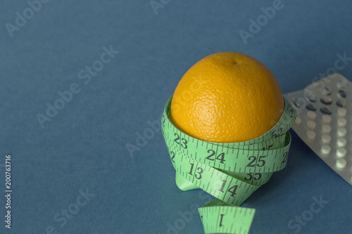 orange with an inch lying on blue background13