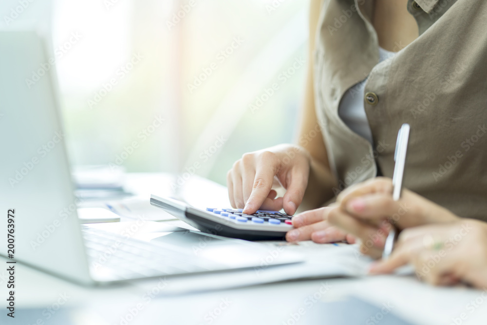 Financial team analyse finance data report, use calculator and note or memo a balance sheet, earning, profit and costing. Accounting teamwork using calculator to analysis annual report for management. Financial team analyse finance data report, use calculator and note or memo a balance sheet, earning, profit and costing. Accounting teamwork using calculator to analysis annual report for management.
