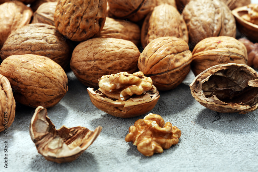 Walnut kernels and whole walnuts on rustic old table Walnut kernels and whole walnuts on rustic old table