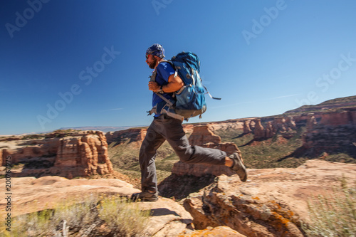 Hiker is sitting on the cliff in Colorado National monument, USA