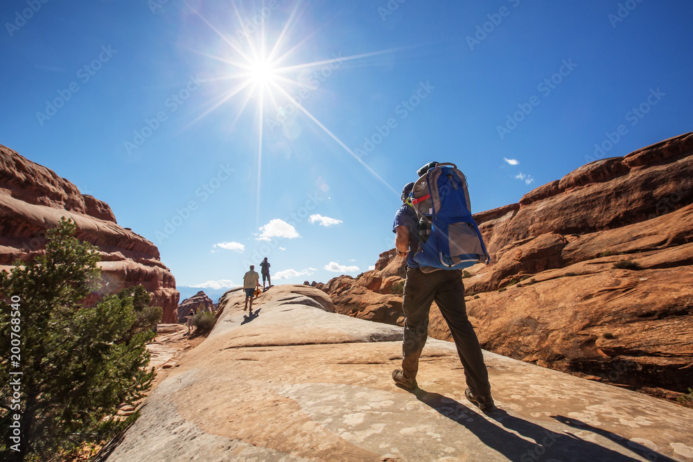 A family with baby son visits Arches National Park in Utah, USA