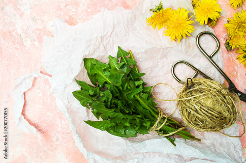 Fototapeta Naklejka Na Ścianę i Meble -  Dandelion leafs and flowers on a table