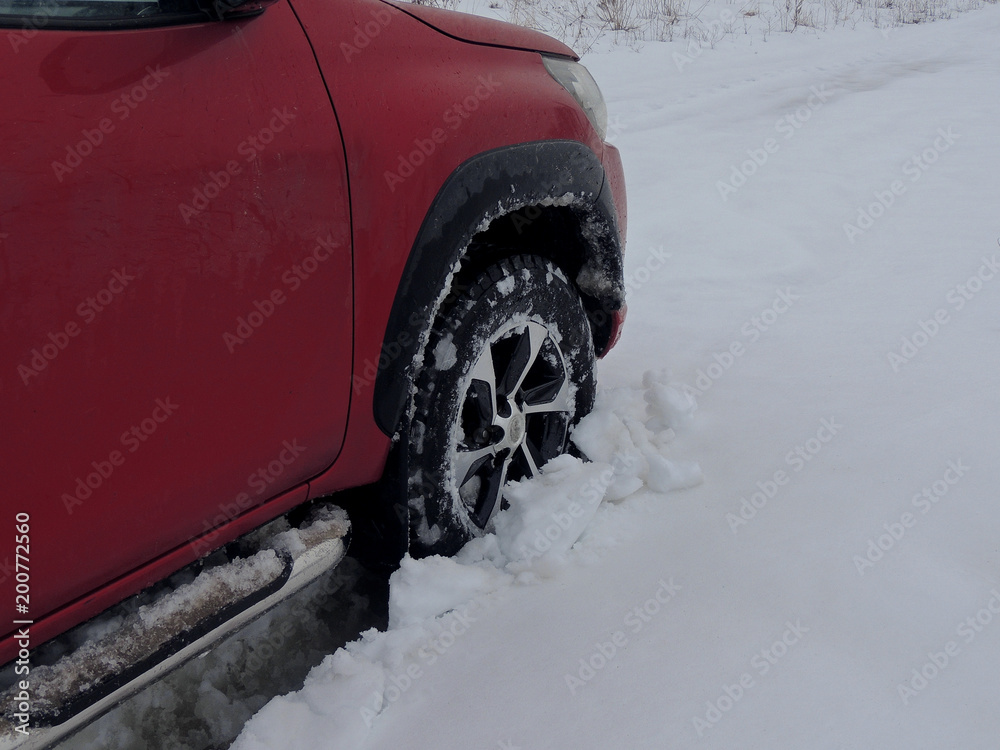 Cars wheel fell into the snow at winter off road  
