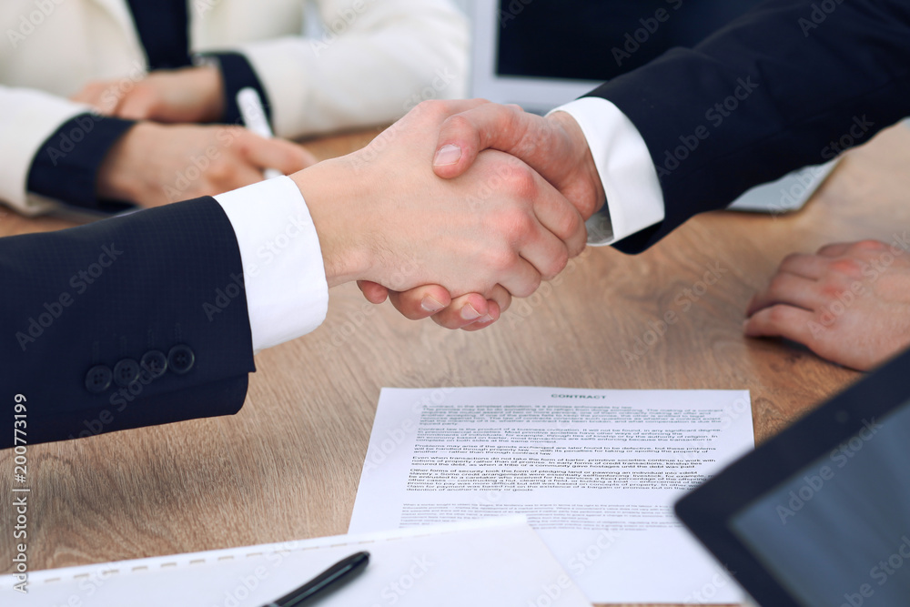 Close up of business people shaking hands at meeting or negotiation in the office. Partners are satisfied because signing contract Close up of business people shaking hands at meeting or negotiation in the office. Partners are satisfied because signing contract