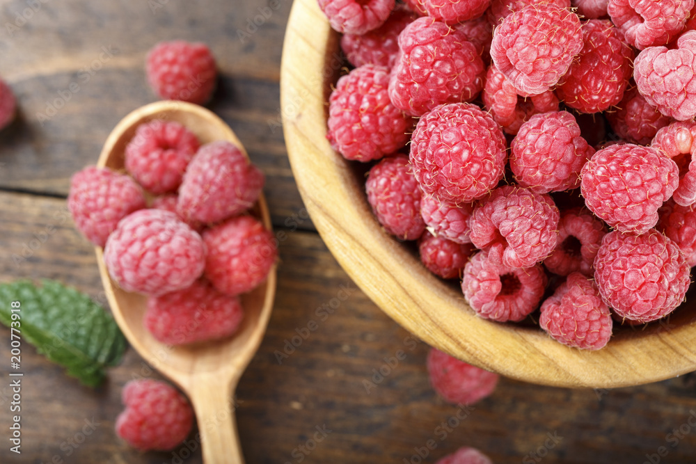Fresh raspberry in a wooden plate Fresh raspberry in a wooden plate