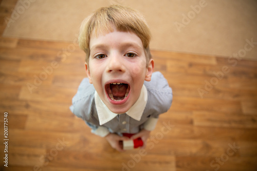 Little boy screaming. boy with open mouth photo
