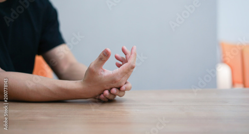 close up employee man massage on his hand and arm for relief pain from hard working ,carpal tunnel syndrome concept