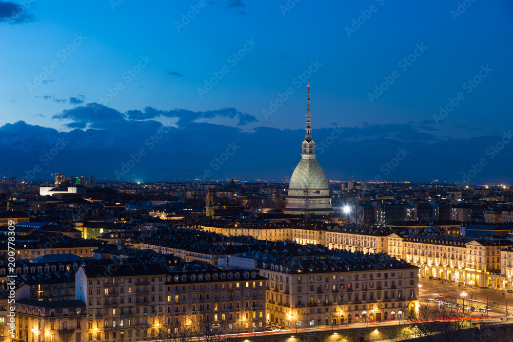 Turin skyline at dusk, Torino, Italy, panorama cityscape with the Mole Antonelliana over the city. Scenic colorful light and dramatic sky.