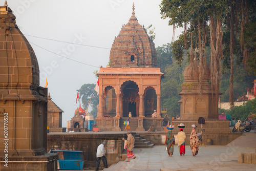 Unrecognizable Indian people walking in Hindu temple at Maheshwar, Madhya Pradesh, India. photo