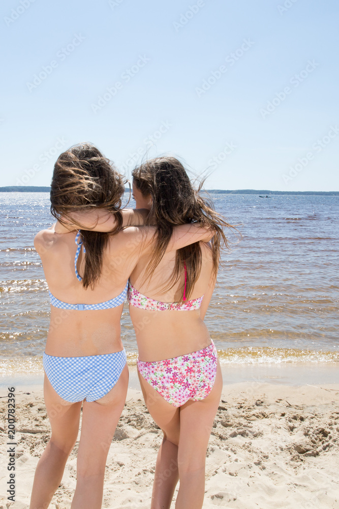 Two Attractive Girls in Bikinis on the Beach. Best Friends Having Fun,  Summer vacation holiday Lifestyle Happy women beauty Stock-Foto | Adobe  Stock